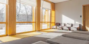 Serene modern treatment center interior with warm natural light symbolizing hope and recovery
